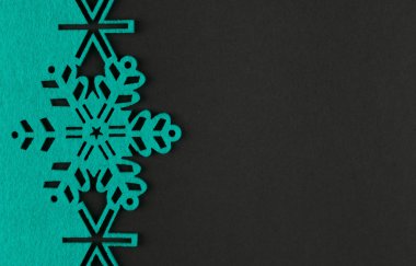 Unusual design christmas background with turquoise snowflakes and copy space on dark grey background clipart