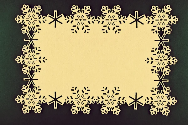 Diseño inusual fondo de Navidad con copos de nieve beige y espacio de copia sobre fondo verde de Navidad — Foto de Stock