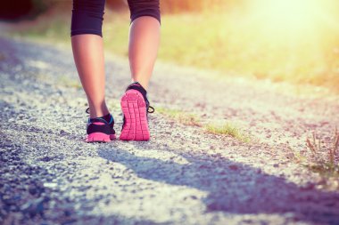 Kadın atlet koşucu. closeup ayakkabı üzerinde. kadın fitness gün batımı koşu egzersiz kavramı.