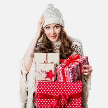 Gorgeous girl holding xmas presents, stunned, funny xmas concept
