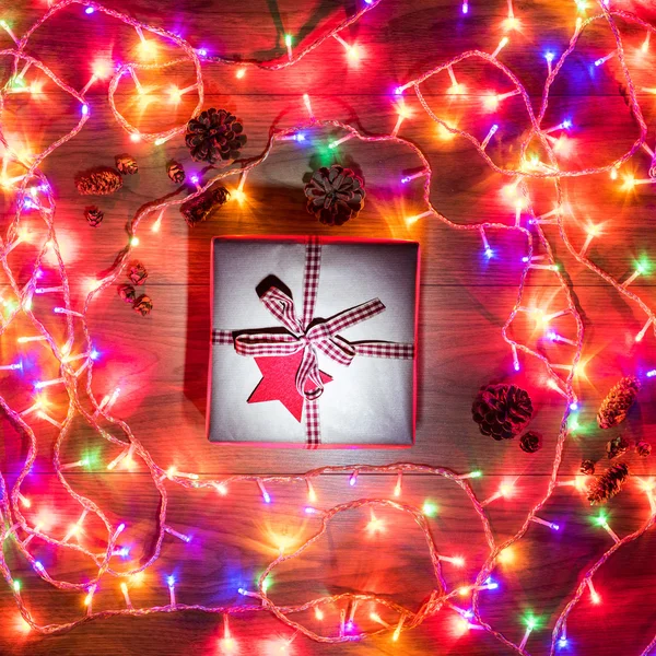 Desk view from above with xmas present and fairy lights, retro xmas concept — Stock fotografie