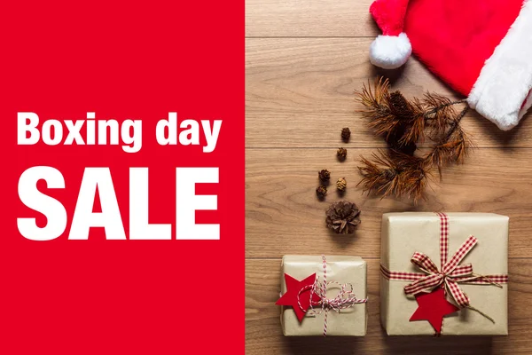 Beautiful presents, Boxing Day sale concept, desk with santa hat, view from above