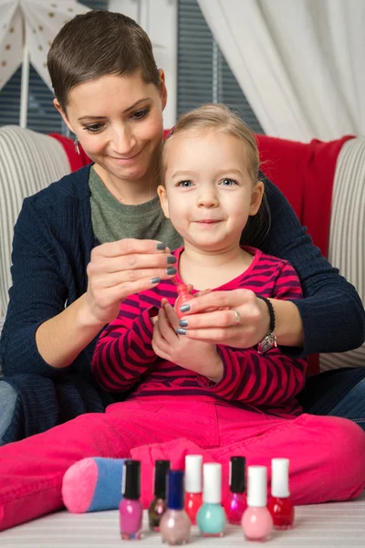 Mother and daughter having fun painting fingernails, family time concept — Stock Photo, Image