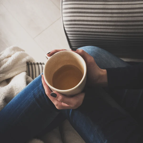 Young woman at home sitting in comfy armchair and drinking tea, view from above — Stock Photo, Image