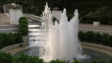 Ilık Kasım gününde Hong Kong parkında bahçenin gölgeli bir parçası ve şelale basamağı.