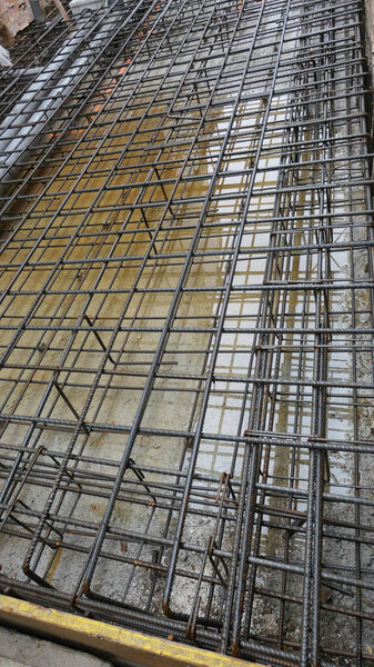 Steel bars awaiting pumped and poured concrete at construction site in central Andalusian village