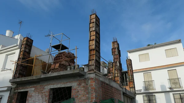 Shuttering on concrete pillar on new build in Spanish village