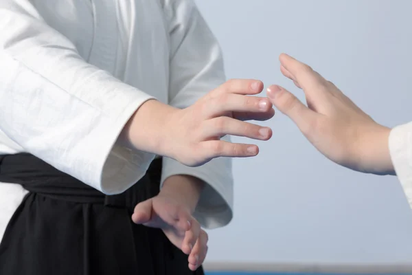 Hands of two girls standing in stance on martial arts training — Stock Photo, Image
