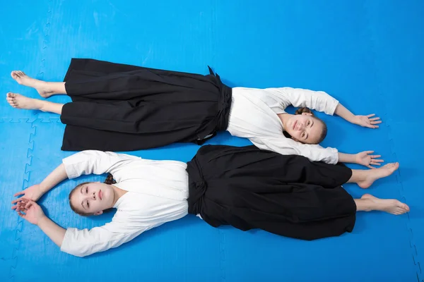 Two girls in black hakama having a rest on Aikido training — Stock Photo, Image