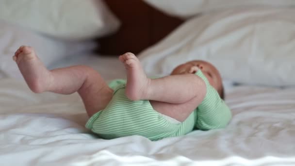 Newborn baby lying on a bed — Stock Video