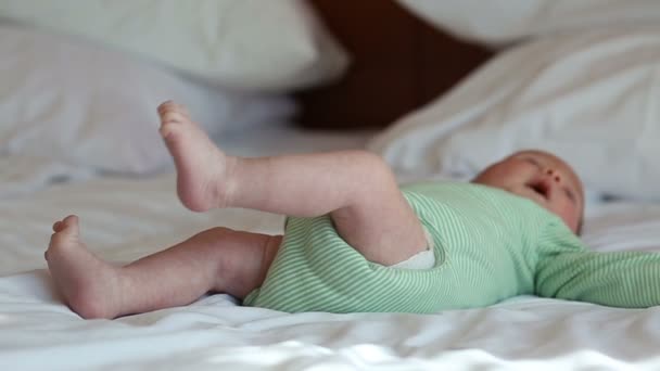 Newborn baby lying on a bed — Stock Video