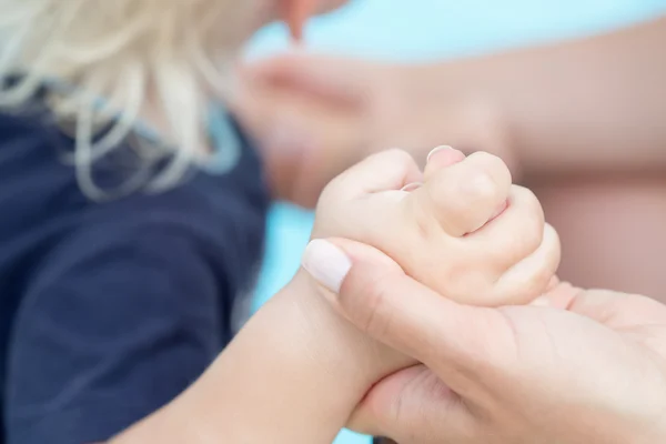 Toddler baby holding his mothers finger — Stock Photo, Image