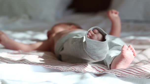 Newborn baby lying on a bed — Stock Video