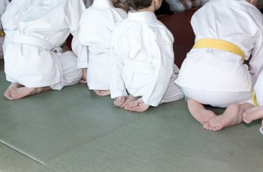 Kimono tatami dövüş sanatları eğitimi seminer üzerinde oturan çocuklarda grup