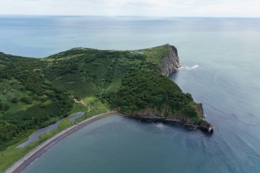 Pasifik Okyanusu 'ndaki yeşil çimlerle kaplı Avacha Körfezi kıyısındaki Kamçatka Yarımadasındaki Mayachny Burnu' nun insansız hava aracı fotoğrafı.