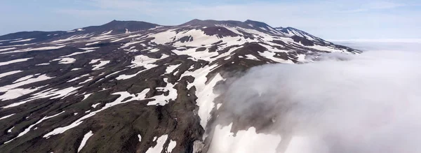 Aerial drone photo of the Gorely Volcano peaks rising above the fog. Kamchatka, Russia — Stock Photo, Image