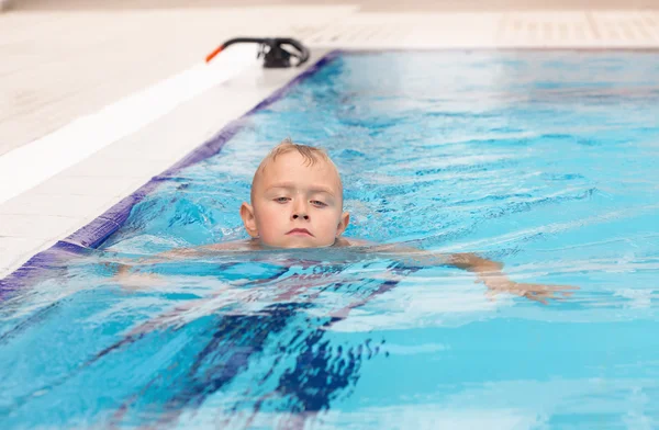 Un chico rubio aprendiendo a nadar — Foto de Stock