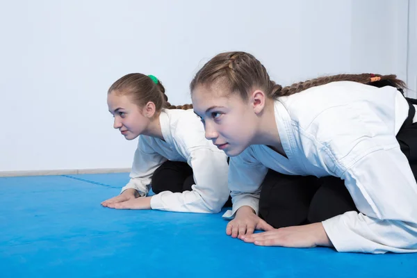 Two girls in hakama bow on Aikido training — Stock Photo, Image