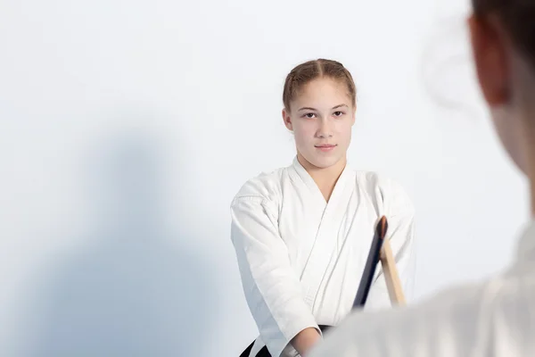 Due ragazze hanno la loro pratica spada su formazione Aikido su sfondo bianco — Foto Stock