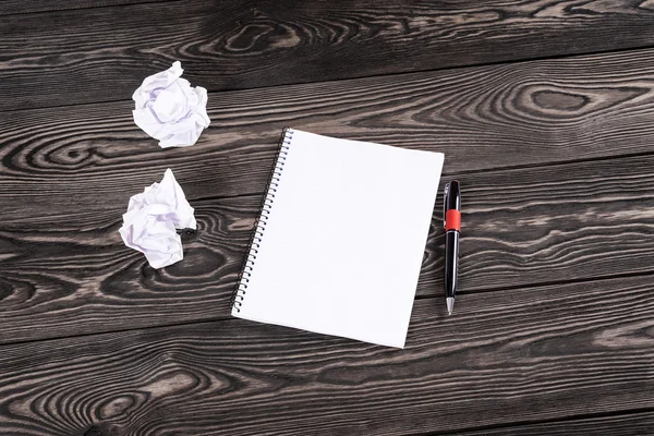 Notebook with pen on old boards — Stock Photo, Image