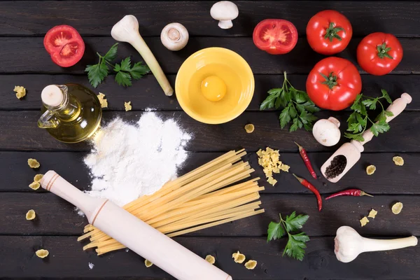 Raw pasta, kitchen table, top view — Stock Photo, Image