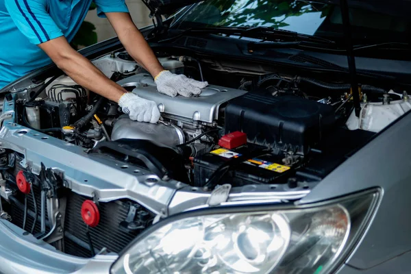 Auto mechanic working in garage. Repair service.