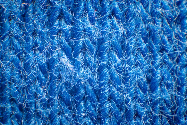 Close-up of synthetic fabric, Blue fiber with gaps, High magnification, Super macro.