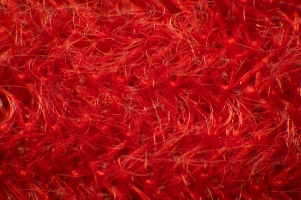 Synthetic fiber photos There is a space between the fibers. Tidy weave, red fiber, high magnification, super macro