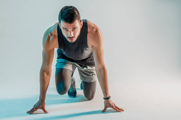 Concentrated european runner on start in studio