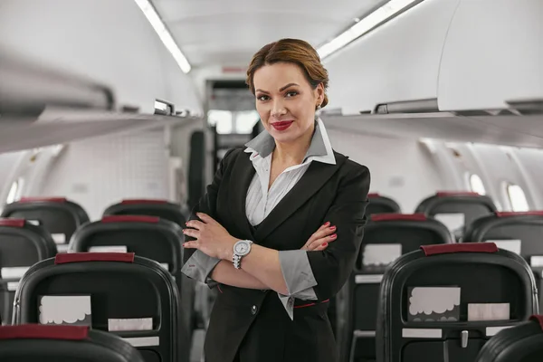Stewardess in passenger cabin of airplane jet