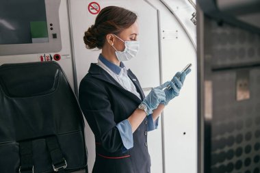Hostes yolcu uçağında cep telefonu kullan