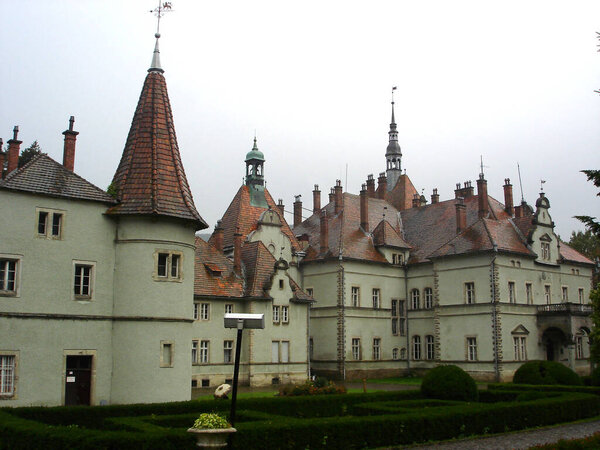 Old castle building with wet red tiled roof and Shenborn Palace towers