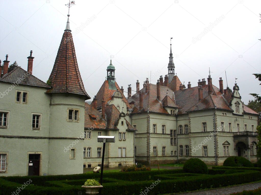 Old castle building with wet red tiled roof and Shenborn Palace towers
