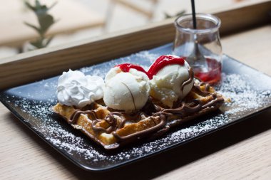 Dondurma, çikolata, ahududu ile Belçika waffle sosu ve creambelgian ile dondurma, çikolata, krema ve frambuaz sos waffle