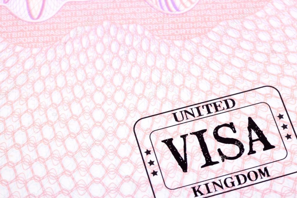 UK visa immigration stamp passport page close up, copy space