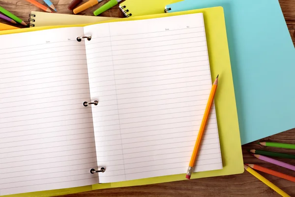 Student's desk with yellow project folder — Stock Photo, Image