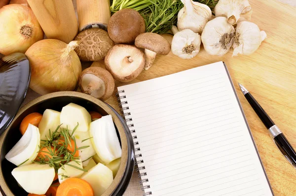 Casserole pot with organic vegetables and herbs on kitchen workt — Stock Photo, Image