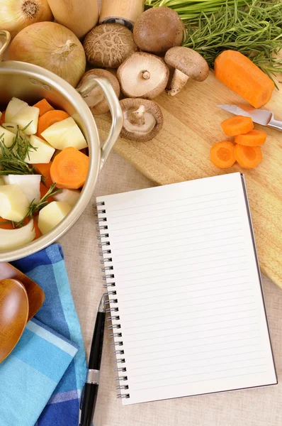 Hrnec kastrol s ekologickou zeleninu a byliny na kuchyňské pracovní stolek — Stock fotografie