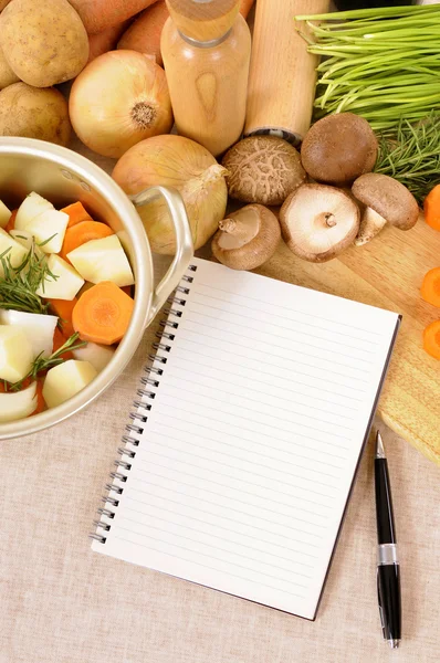 Casserole pot with organic vegetables and herbs on kitchen workt — Stock Photo, Image