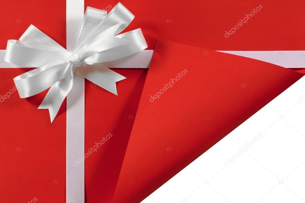 Christmas or birthday white satin gift ribbon and bow on red pap