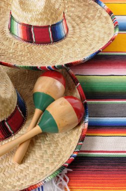 Mexican sombreros with maracas and traditional serape blankets. clipart