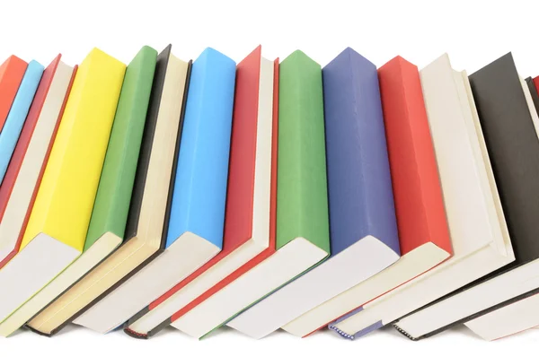 Leaning row of colorful books — Stock Photo, Image