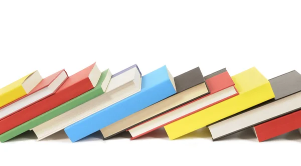 Leaning row of colorful books — Stock Photo, Image