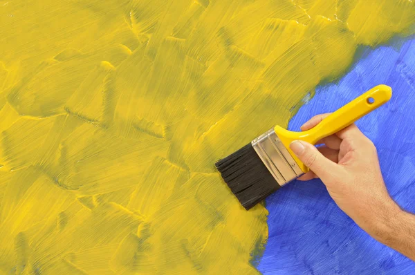 Partly painted yellow and blue wall — Stock Photo, Image