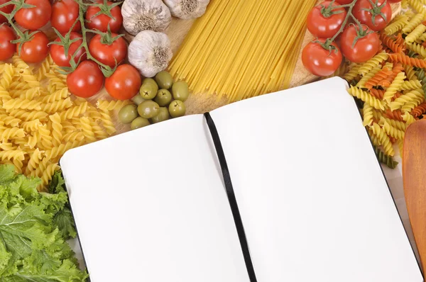 Pasta with blank recipe book and chopping board — Stock Photo, Image