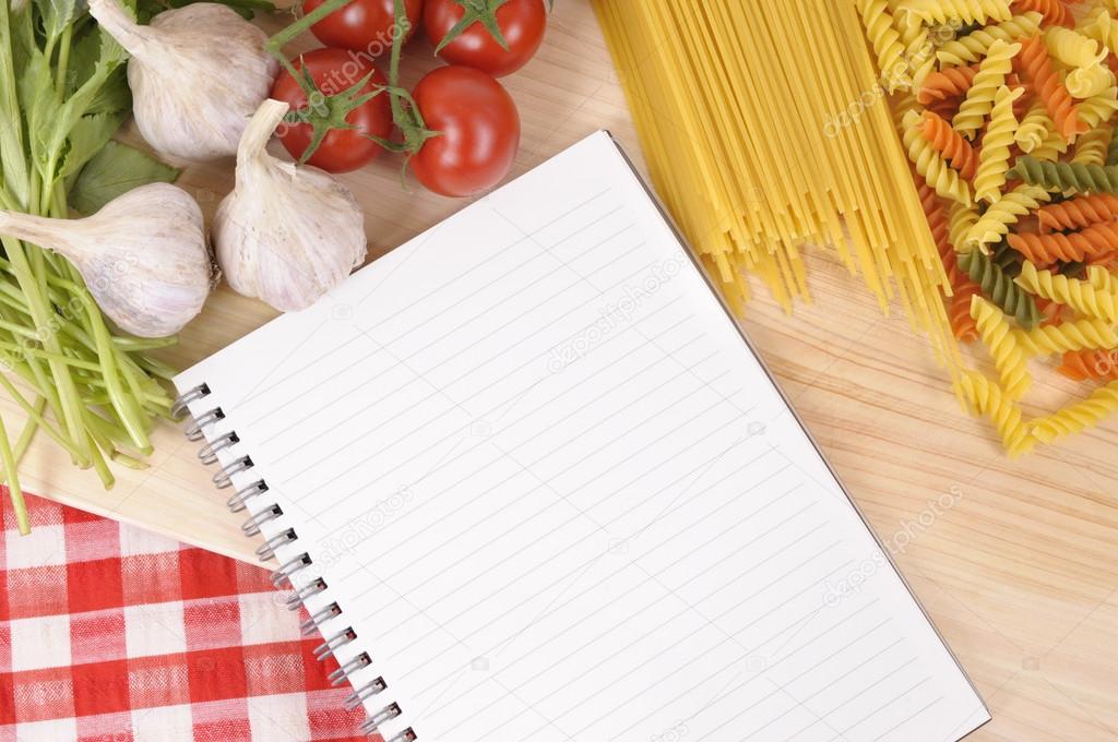 Pasta with blank recipe book and red check tablecloth