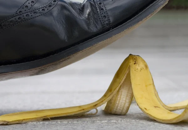 Businessman about to slip on a banana skin — Stock Photo, Image