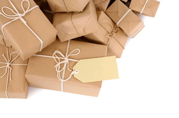 Untidy pile of brown parcels with label