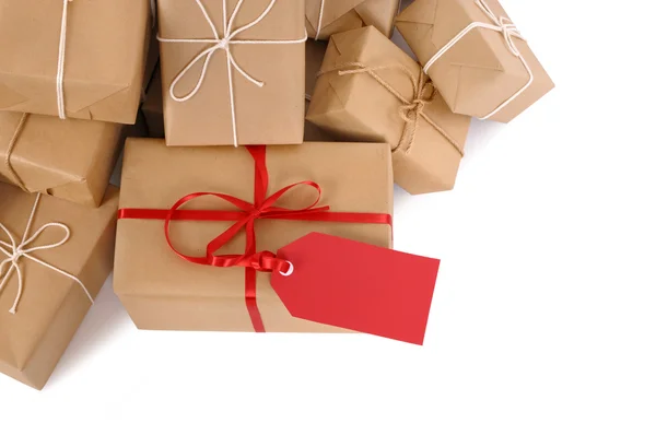 Group of parcels, red gift tag — Stock Photo, Image