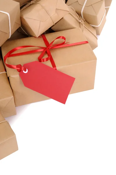 Group of parcels, red gift tag — Stock Photo, Image